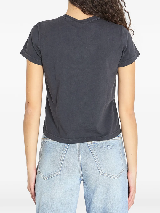 black t-shirt worn by a person, showing the t-shirt fit