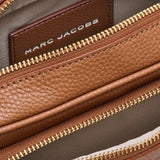 Close up of brown bag, showing texture of the leather fabric
