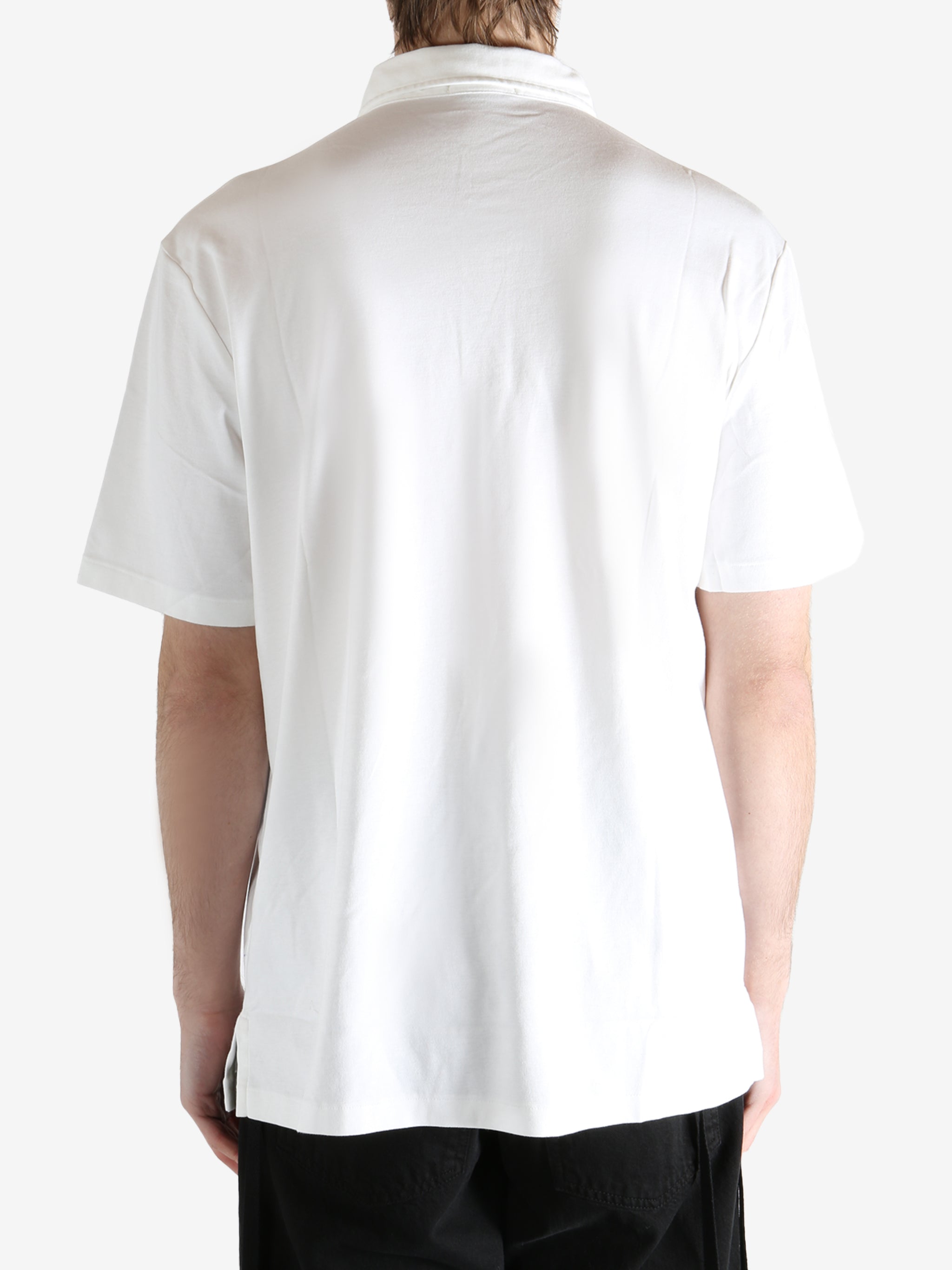 White t-shirt worn by a person, showing the shirt's fit