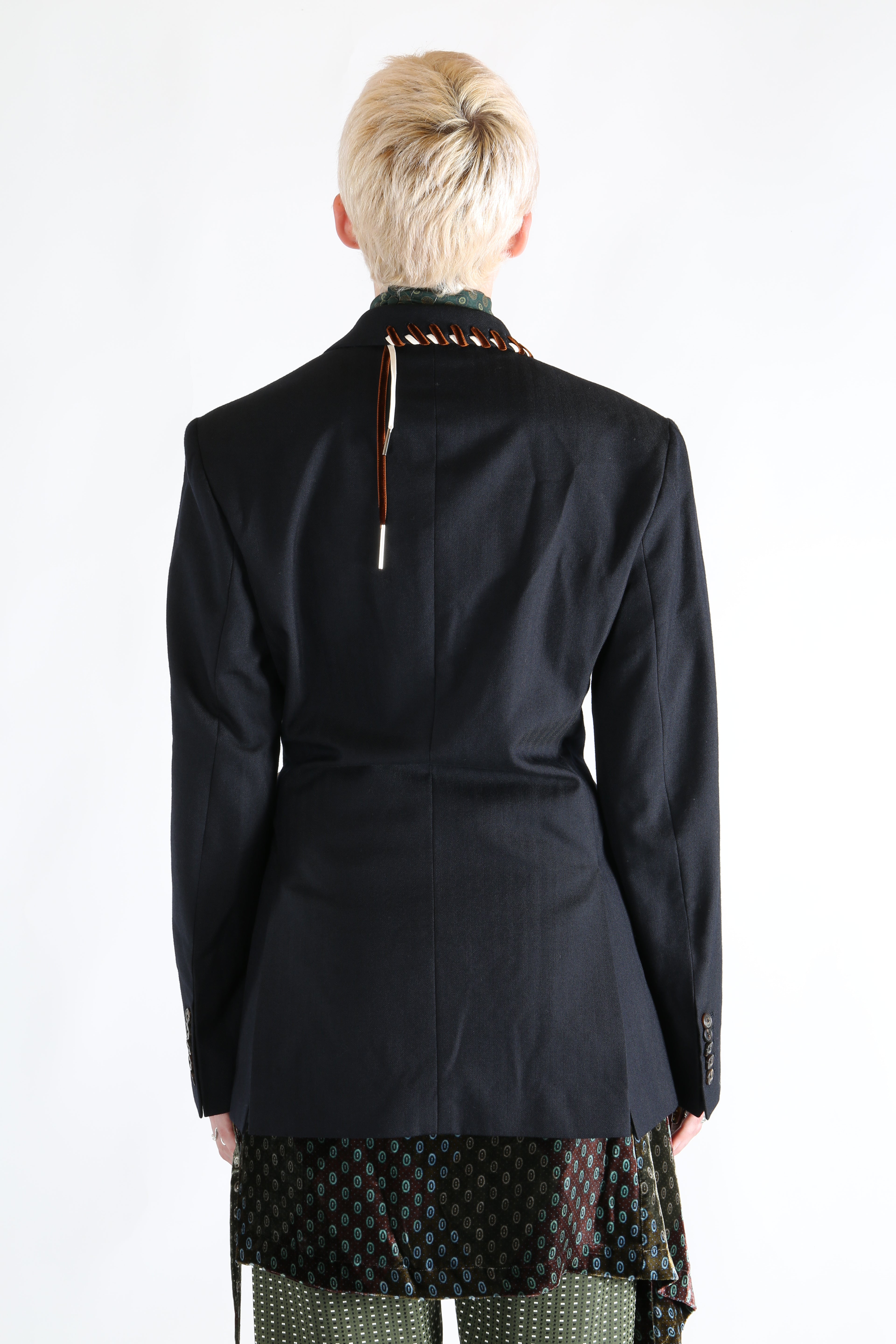 Navy coat worn by a person, showing the coat's fit