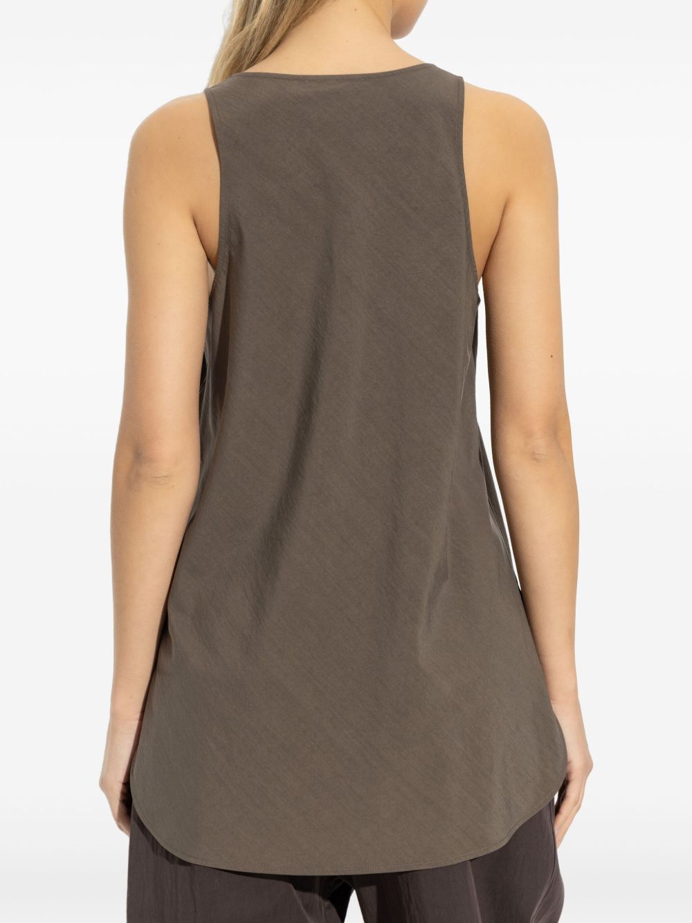 Brown top worn by a person, showing the top fit