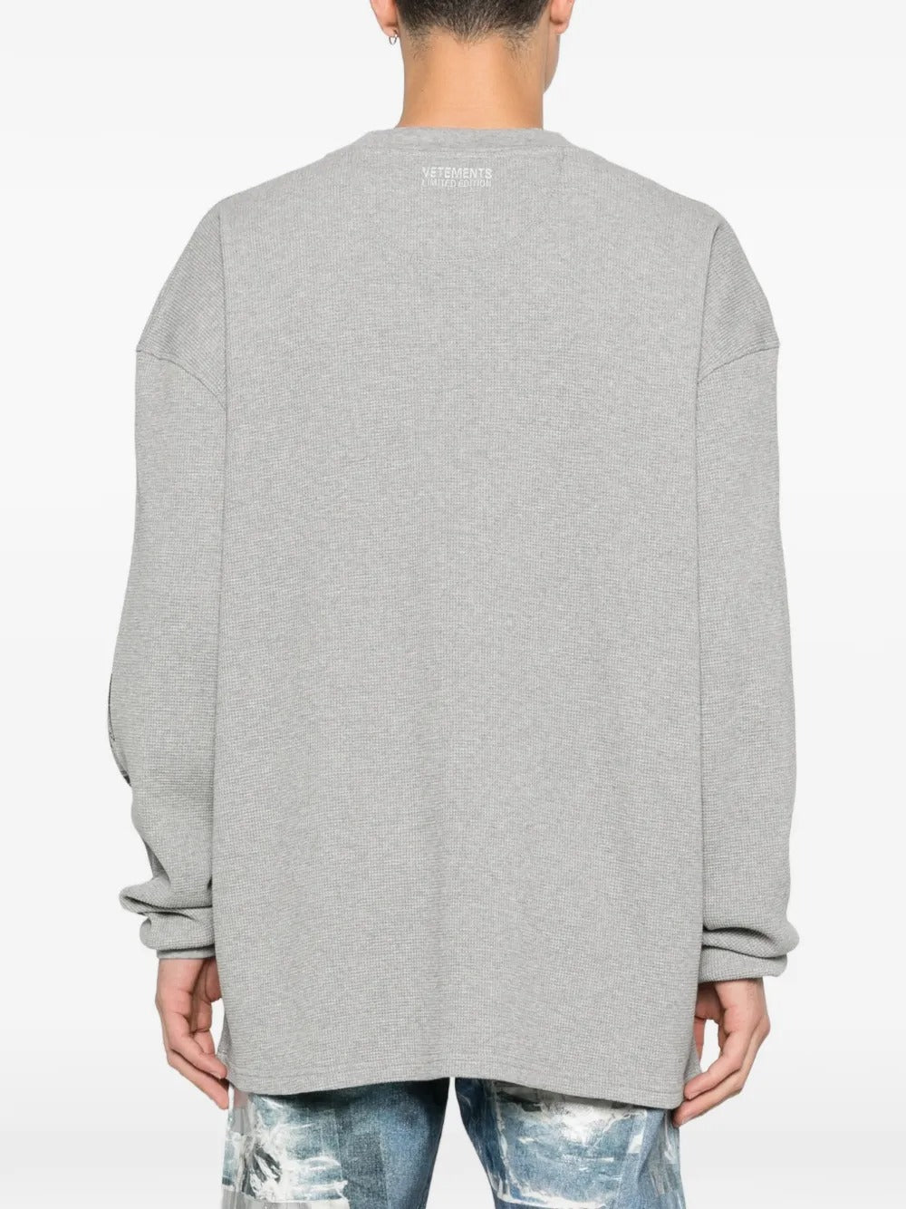 Grey sweats worn by a person, showing the sweats' fit