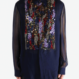 Navy blue shirt worn by a person, showing the shirt's fit