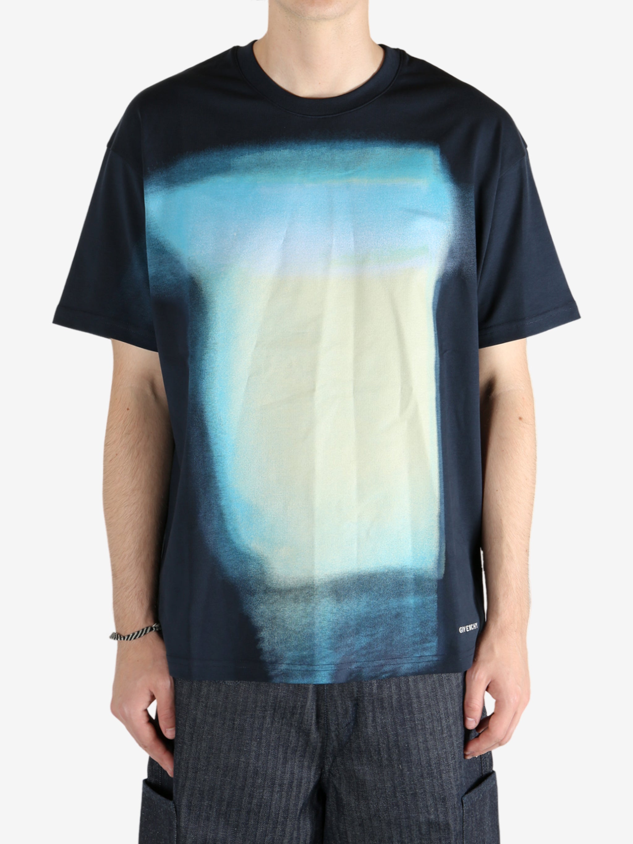 Blue t-shirt worn by a person, showing the shirt fit