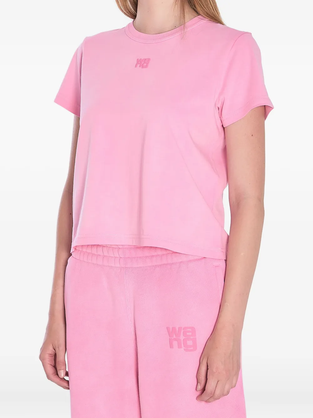 Pink t-shirt worn by a person, showing the shirt's fit