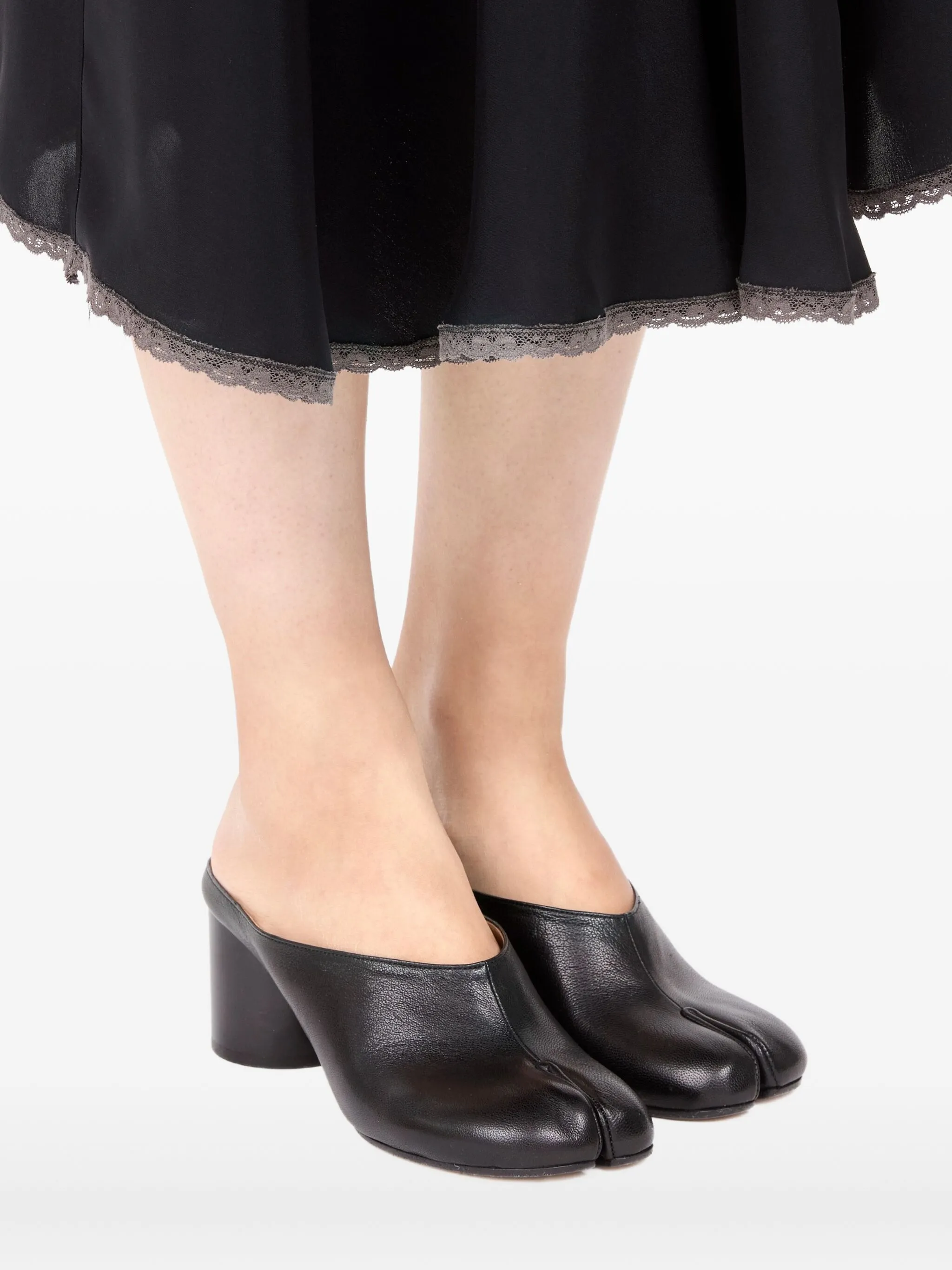black mules worn by a person, showing the mules fit