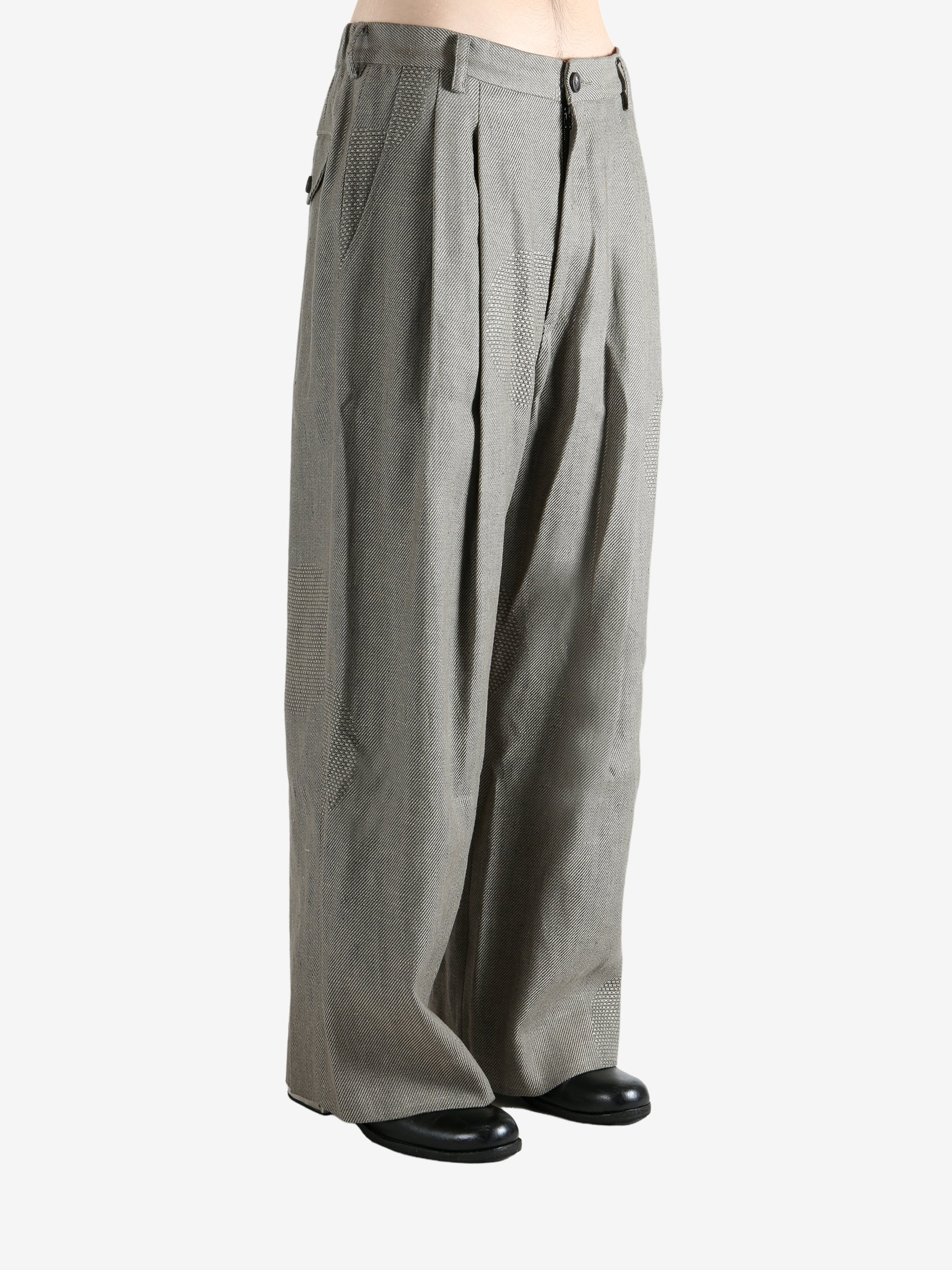 Grey pants worn by a person, showing the pants' fit