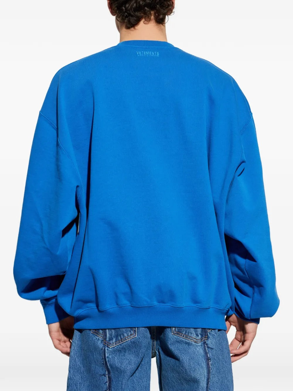 blue sweatshirt worn by a person, showing the sweatshirt fit