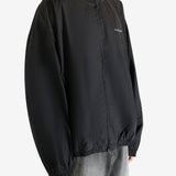 Black coat worn by a person, showing the coat's fit