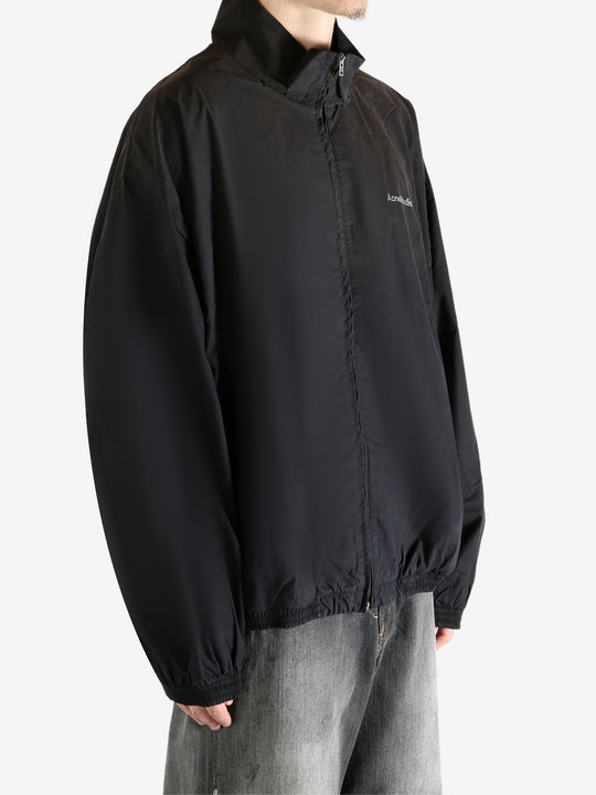 Black coat worn by a person, showing the coat's fit