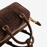 Close up of the brown bag, showing texture of the calfskin fabric