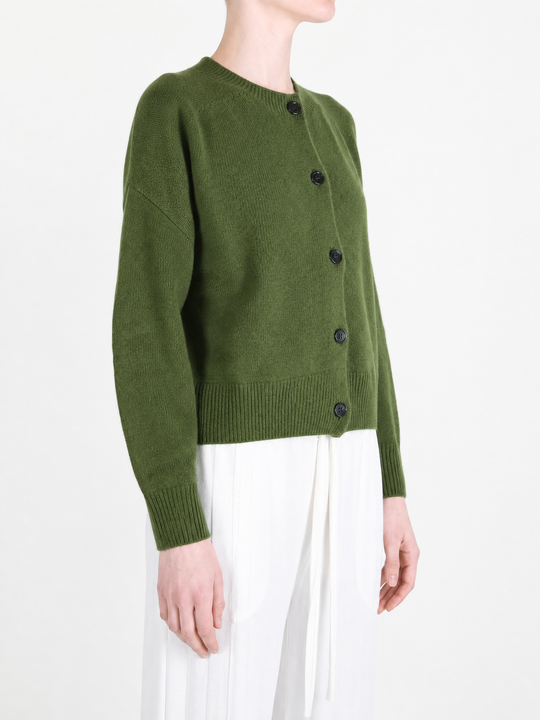 Green knitwear worn by a person, showing the knitwear fit