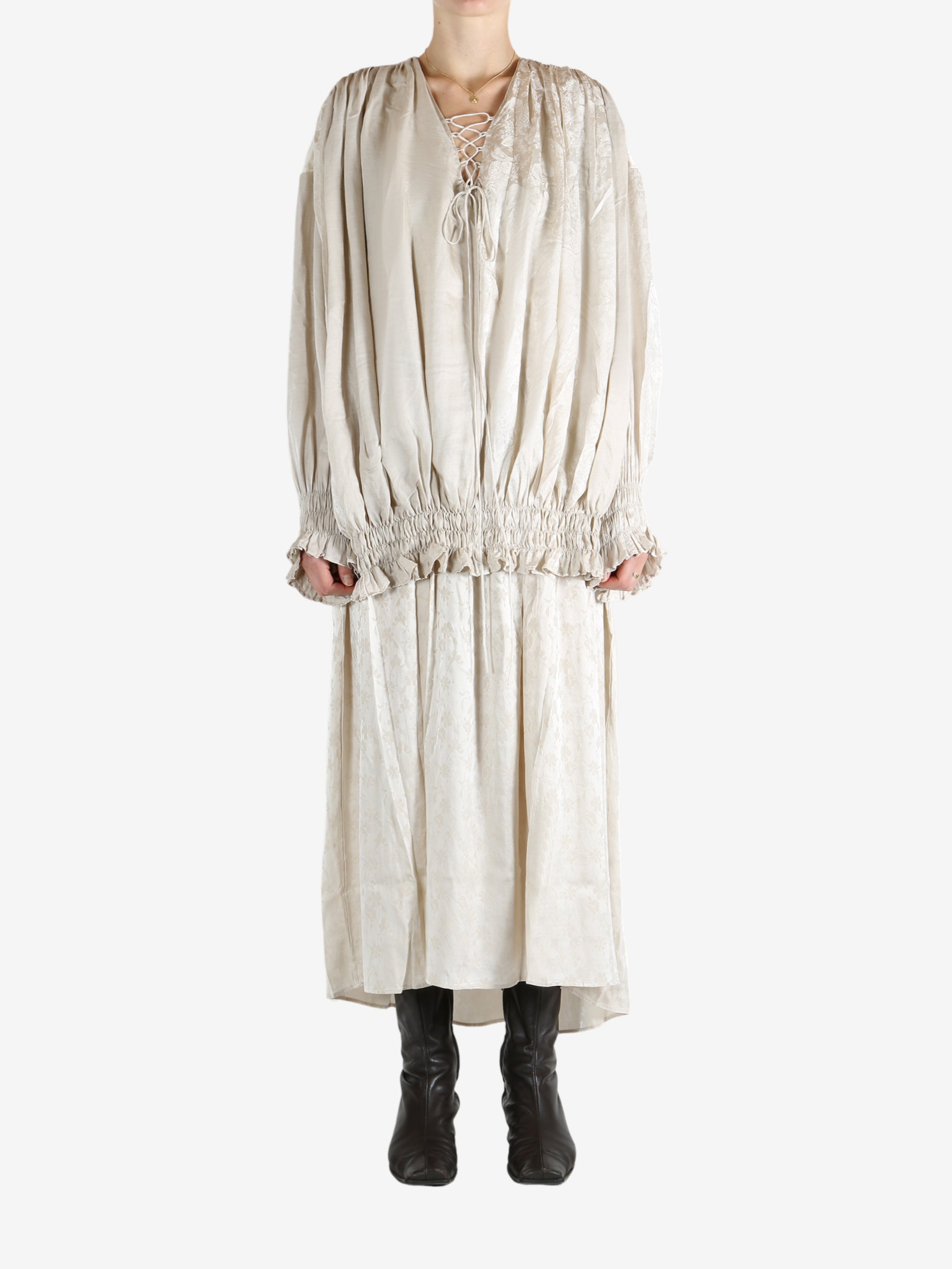 White dress worn by a person, showing the dress's fit