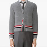 Grey knitwear worn by a person, showing the knitwear fit