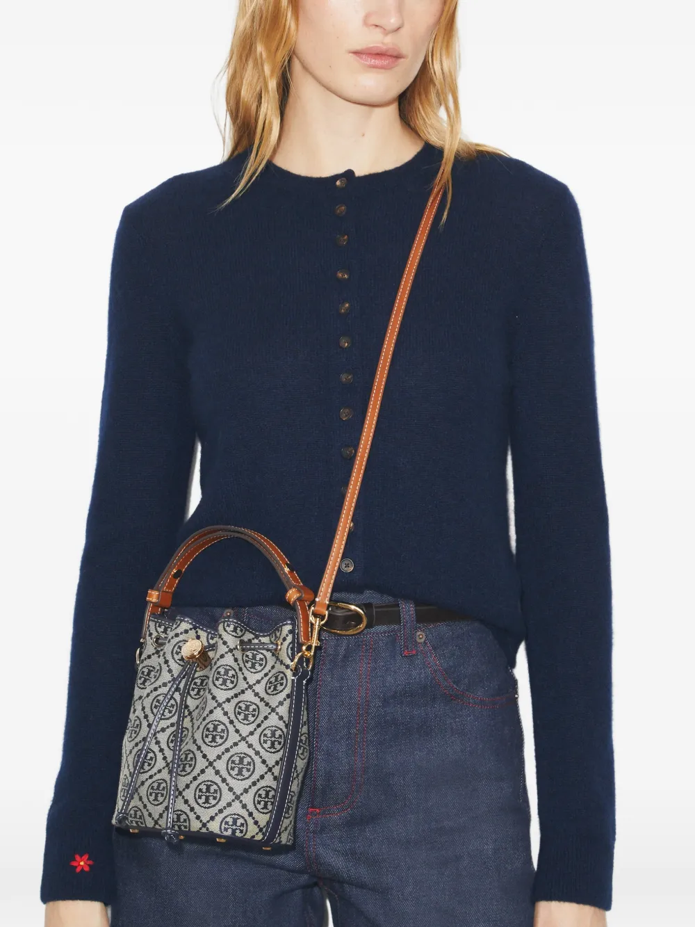 Navy bucket bag by a person, showing the bucket bag fit