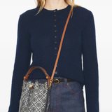 Navy bucket bag by a person, showing the bucket bag fit
