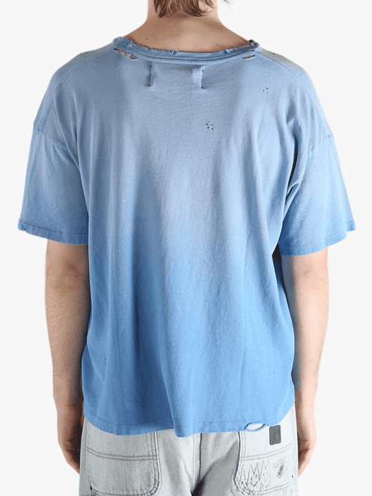 Blue t-shirt worn by a person, showing the shirt's fit