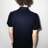 Navy shirts worn by a person, showing the shirts fit