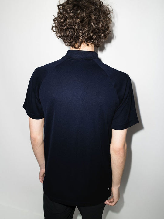 Navy shirts worn by a person, showing the shirts fit