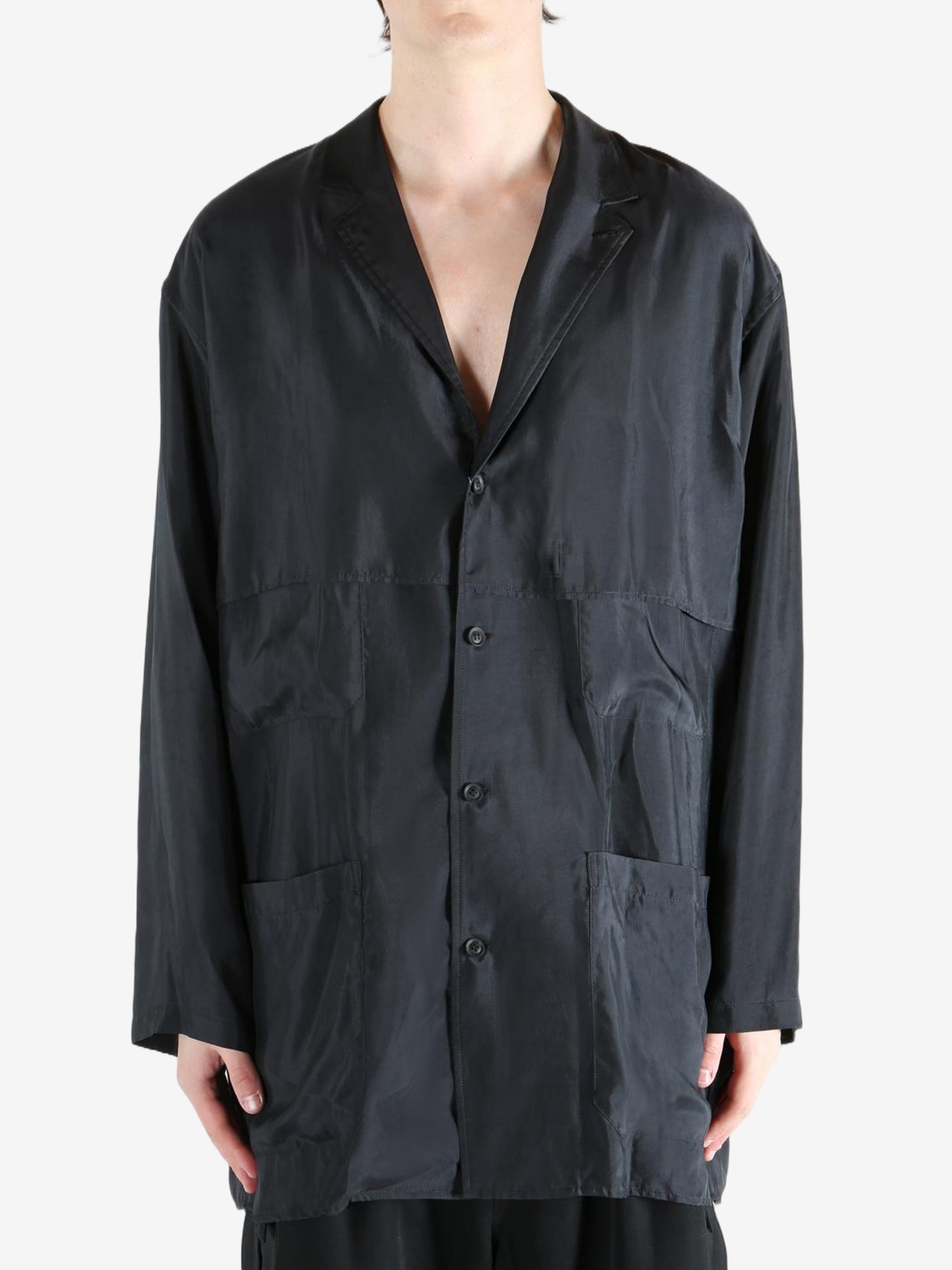 Black shirt,worn by a person, showing the shirt's fit