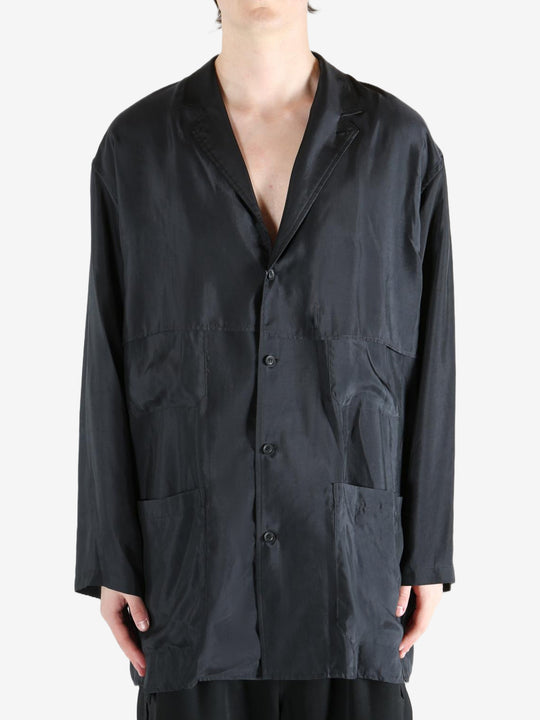 Black shirt,worn by a person, showing the shirt's fit