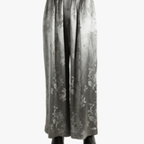 Grey pants worn by a person, showing the pants' fit