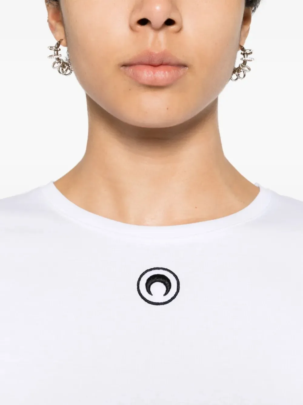 Close up of white t-shirt, showing texture of the orangic cotton fabric