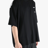 Black t-shirt worn by a person, showing the shirt's fit