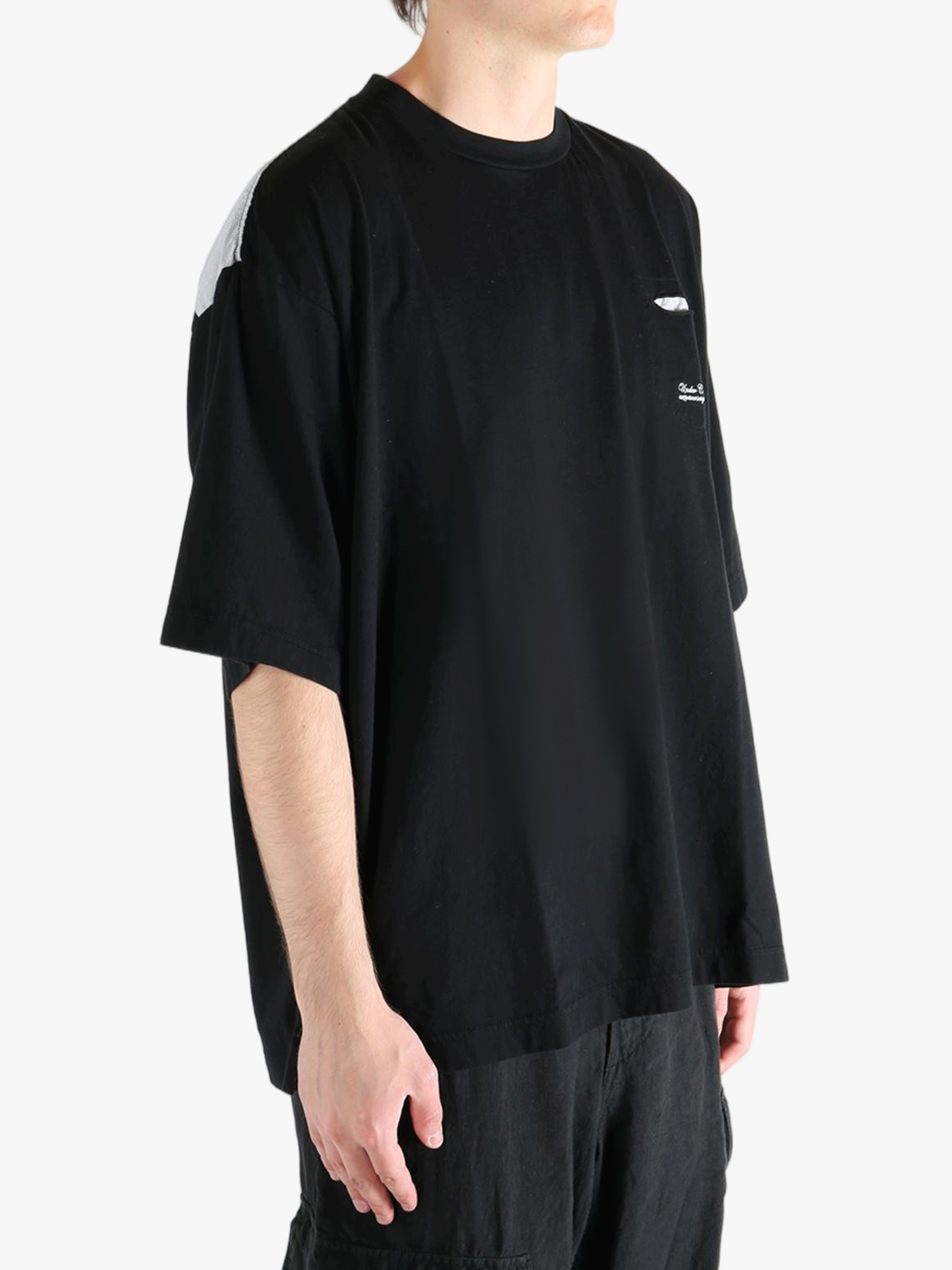 Black t-shirt worn by a person, showing the shirt's fit