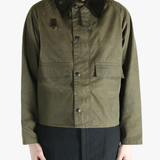 Green jacket worn by a person, showing the jacket fit