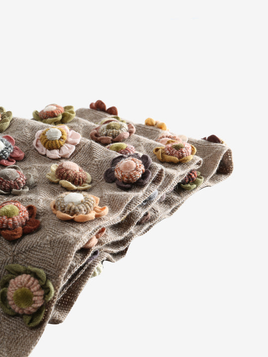 Close up of tan scarves, showing texture of the wool and cotton and linen fabric