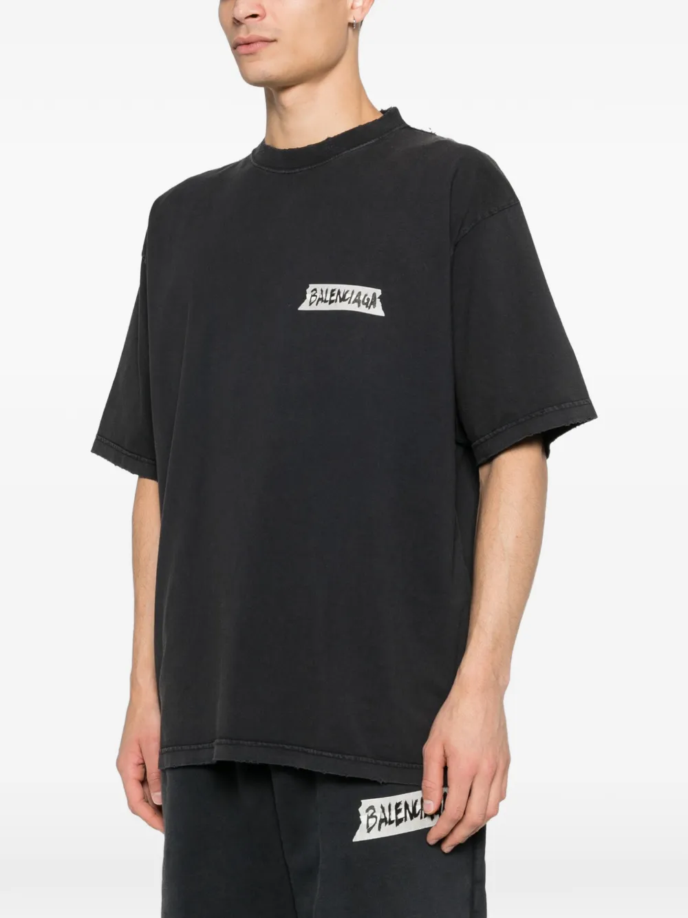 black t-shirt worn by a person, showing the t-shirt fit