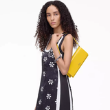 Yellow bag worn by a person, showing the bag's fit