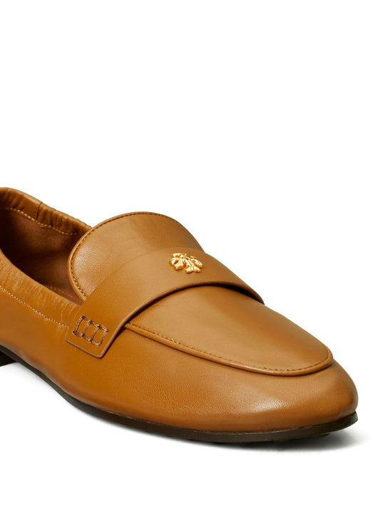 Close up of brown loafer, showing texture of the calf leather fabric