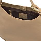 Close up of the tan bag, showing texture of the leather fabric