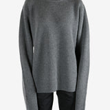Grey knitwear worn by a person, showing the knitwear's fit