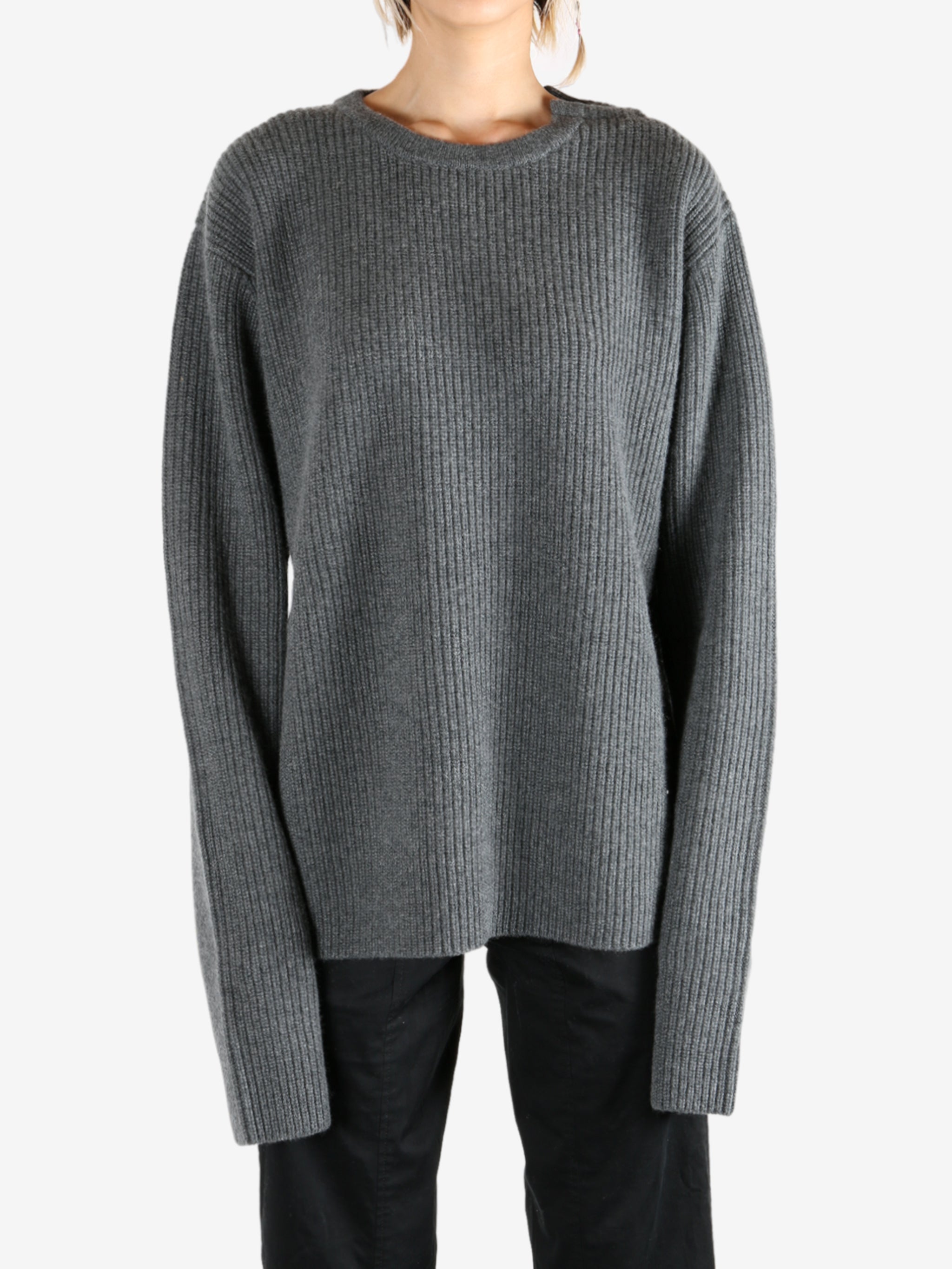 Grey knitwear worn by a person, showing the knitwear's fit
