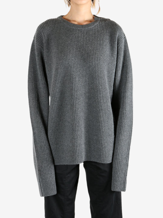 Grey knitwear worn by a person, showing the knitwear's fit