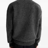 Black sweater worn by a person, showing the sweater's fit