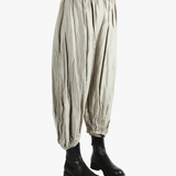 Grey pants worn by a person, showing the pants fit