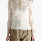 White top worn by a person,showing the top fit