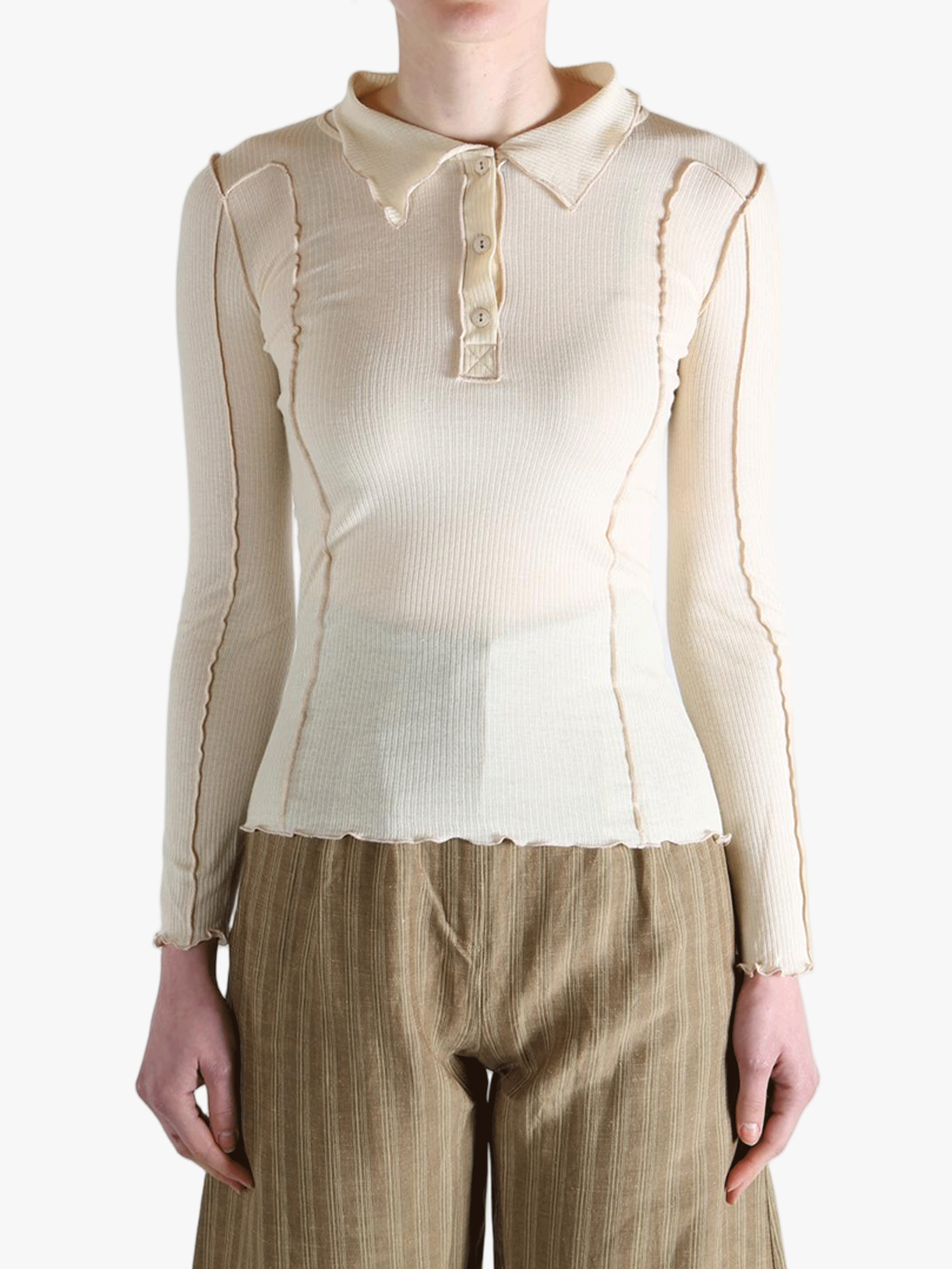 White top worn by a person,showing the top fit