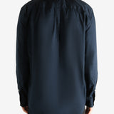 Navy shirt worn by a person, showing the shirt's fit