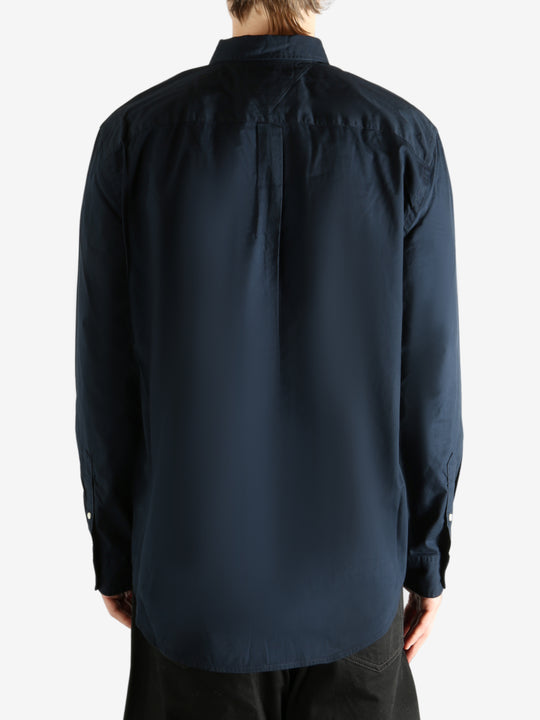 Navy shirt worn by a person, showing the shirt's fit