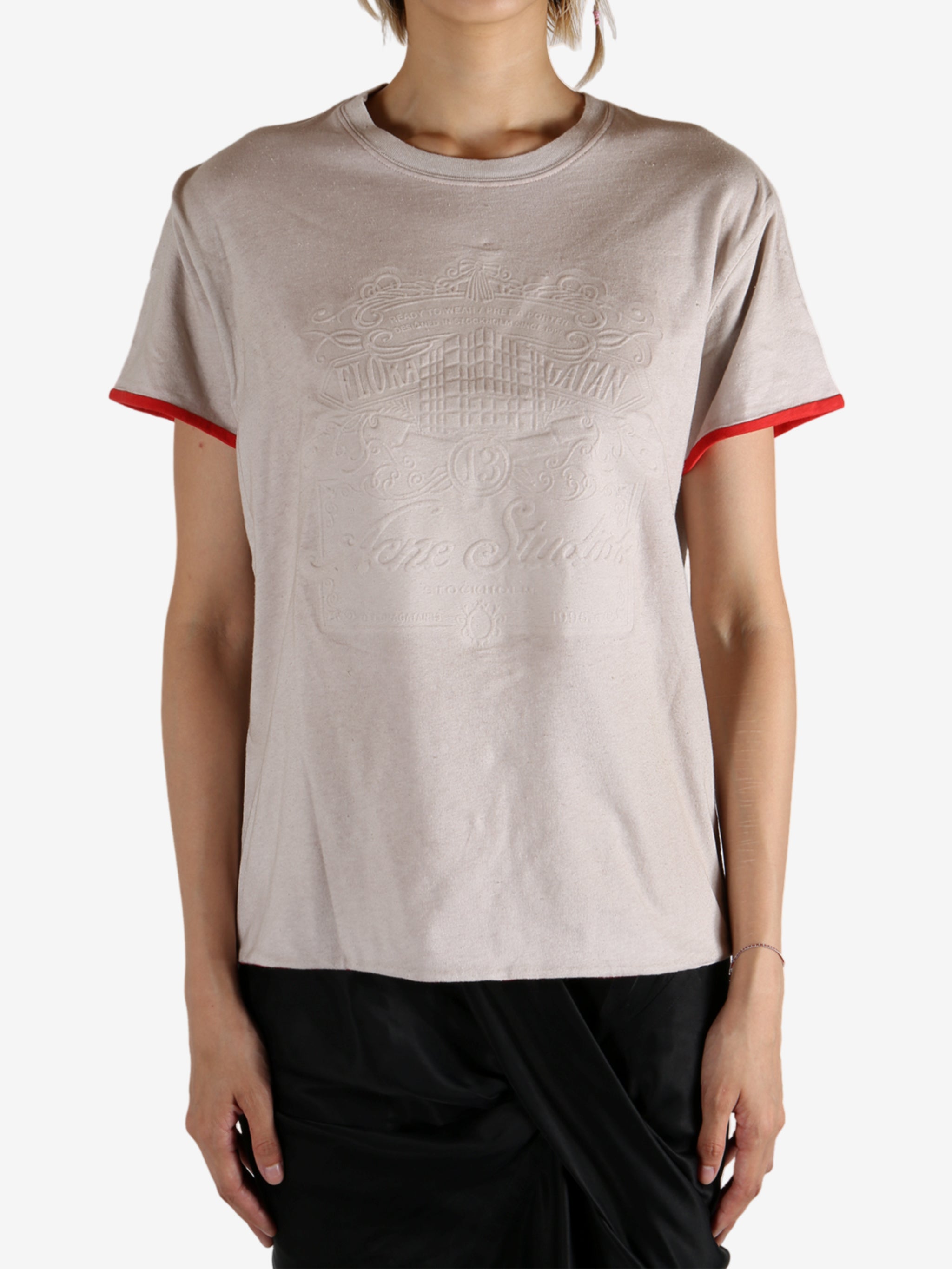 White t-shirt worn by a person, showing the shirt's fit