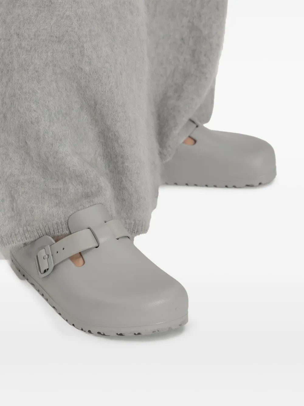 Grey sandals worn by a person, showing the sandals' fit