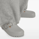 Grey sandals worn by a person, showing the sandals' fit