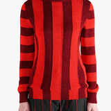 Red knitwear worn by a person, showing the knitwear fit