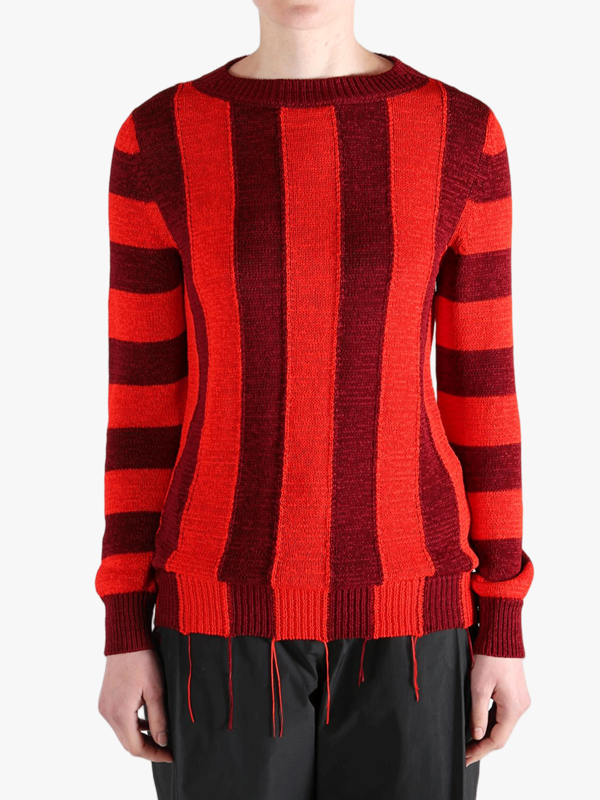 Red knitwear worn by a person, showing the knitwear fit