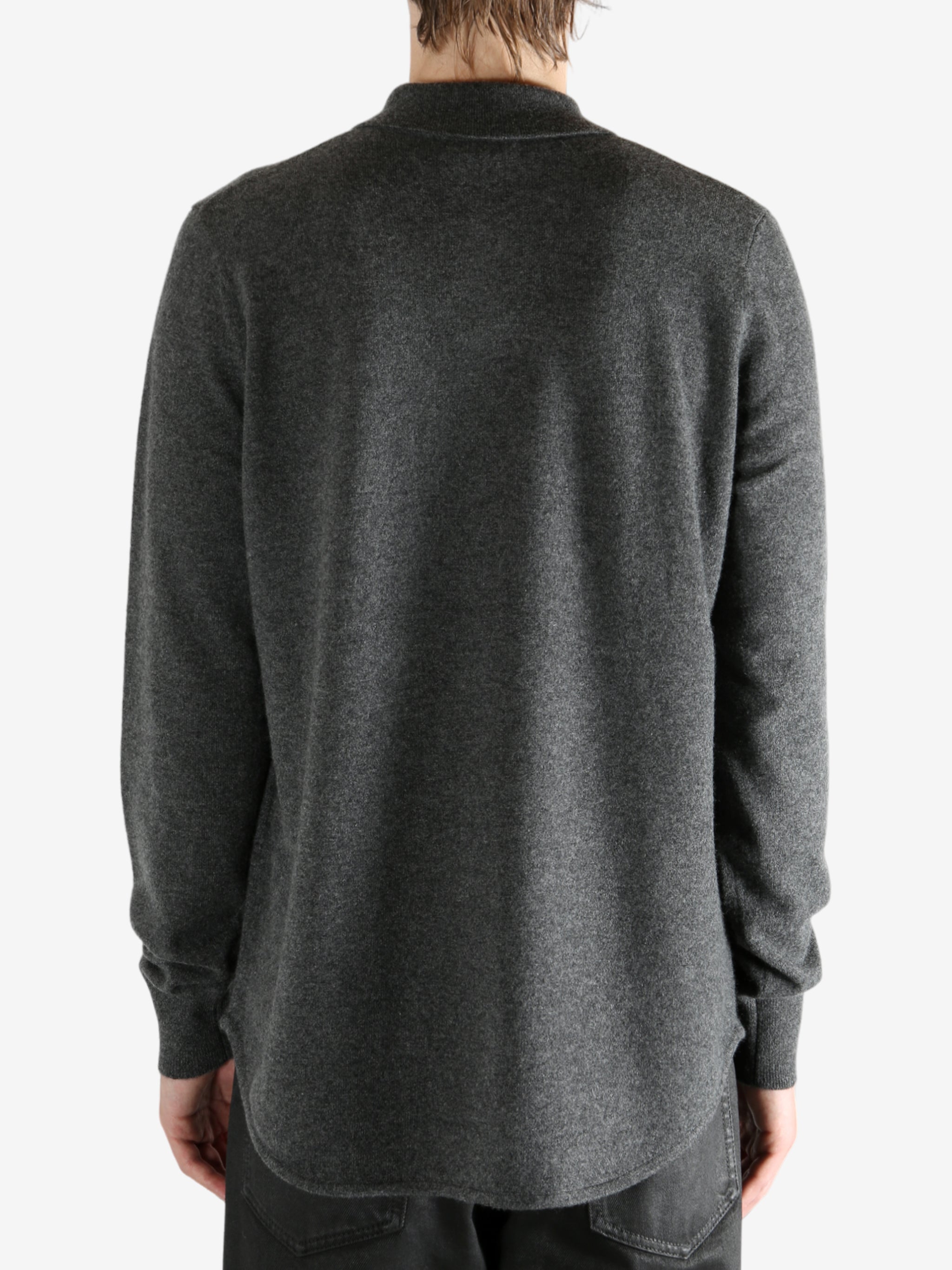 Grey shirt worn by a person, showing the shirt's fit